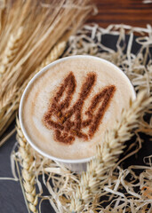Cup cappuccino coffee cup with foam patriotic pattern, coat of arms  Ukraine, stencil decor latte...