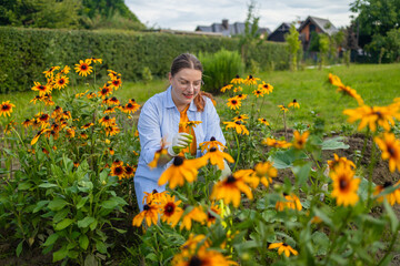 Gardening and agriculture concept. Young woman farm worker gardening flowers in garden. Gardener planting flowers for bouquet. Summer gardening work. Girl gardening at home in backyard. High quality