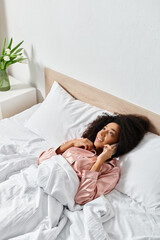 A doll rests peacefully on a neatly made bed with white sheets, adding a touch of whimsy to the cozy bedroom setting.