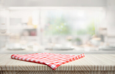 Fabric cloth or placemat on wood table top on blur kitchen room background.For montage product...
