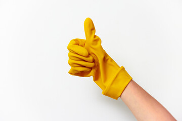 Yellow rubbergloved hand showing thumbs up on white background with copy space for text or logo