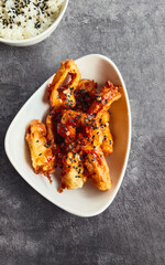 Battered squid in sweet and sour sauce and sesame seeds