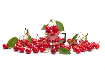 Sweet ripe cherries in a glass cup .