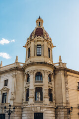 Close-up of an ornate tower on a historic building in Valencia. The detailed architecture and bright sky highlight the city s cultural heritage and artistic beauty.