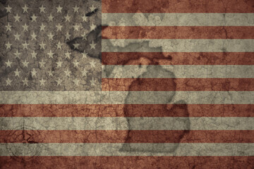 map of michigan state and flag of united states of america on a old vintage crack paper background .