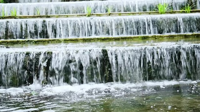 Slow motion of water running down the stone step