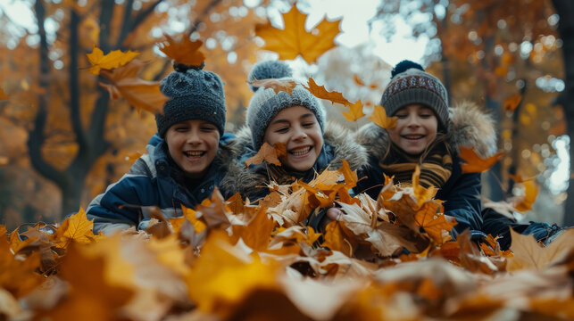 Friends having fun throwing leaves in autumn leaves in park, enjoying autumn weather season.