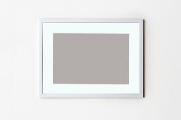 Blank picture frame on white wall background. Stylish photoframe with passe-partout