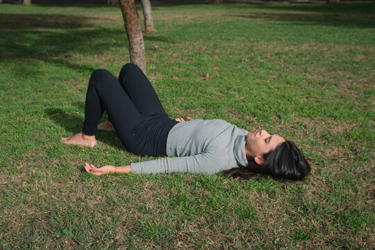 fainted woman trying to recover lying on beach