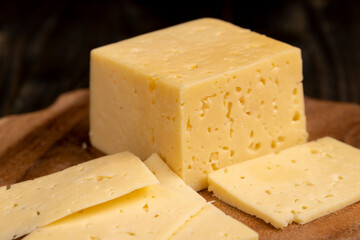 a piece of cheese with holes on the table