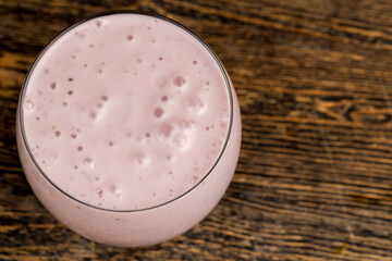 pink yogurt with chunks and taste of red strawberries