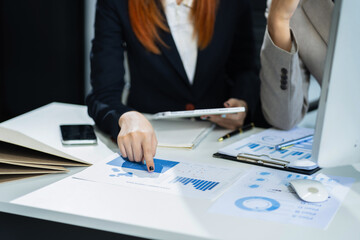 Businessmen team or financial data analysts working with tablets and laptop computers and data graphs together. Plan to analyzing projects in the office.