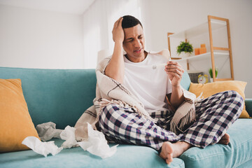 Photo of unhappy upset guy sleepwear pajama measuring temperature feeling bad indoors house...