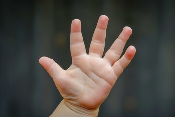 Baby is showing an open hand with five fingers