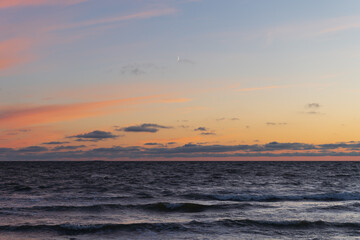 Seascape in Estonia during the waves after sunset in summer.