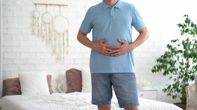 Stomach ulcer, man with abdominal pain suffering at home, symptoms of gastritis, diseases of the digestive system, health problems concept