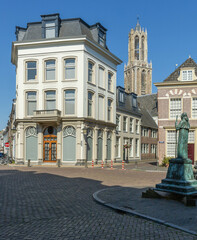 Fototapeta premium Pausdam Utrecht with statue of Adrian VI surrounded by historic buildings and the cathedral Dom tower in the background