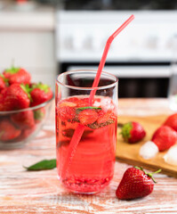 Summer refreshing cocktail with strawberries and fresh mint and ice cubes. Close-up. Selective focus.