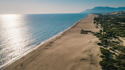 Patara is a Turkish beach famous for its giant sand dunes. Aerial photo taken with a drone. A magnificent nature photography emerges as the sun reflects light onto the sea. Antalya, Turkey.