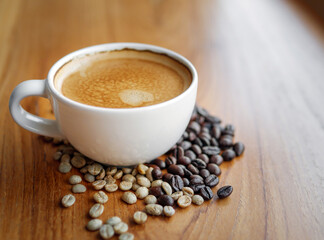 Espresso cup  coffee and coffee bean on wooden table in morning