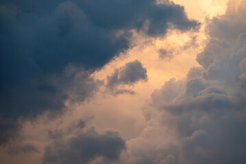 Beautiful clouds of gentle colors on the sky. Rainy clouds, sunshine on the background, majesty and ideality of nature