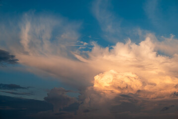 White clouds under sunshine on the sky after the rain. Concept of changeable weather, beauty of the sky, greatness of nature