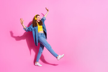 Full length photo of cheerful pretty lady dressed denim jacket earphones dancing empty space isolated pink color background