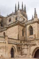 Obraz premium Vertical contrasts: tiered walls with windows and spires of Burgos Gothic Cathedral.