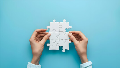 Hands holding pieces of a white jigsaw puzzle over a blue background, symbolizing problem-solving, teamwork, and strategy.