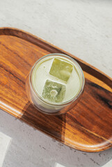 glass of matcha green tea on the table in cafe