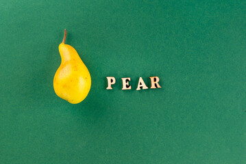 fresh pear closeup. Green background with yellow-green pears