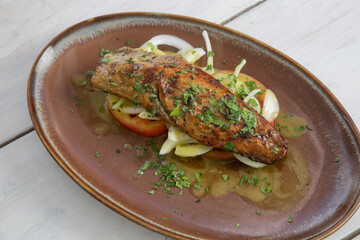 Grilled mackerel fish on fresh vegetables with olive oil