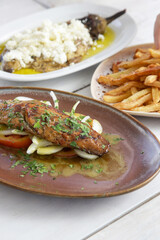 Grilled mackerel fish on fresh vegetables with olive oil