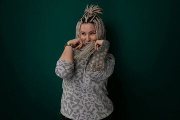 Woman With Dreadlocks Standing Against Green Wall