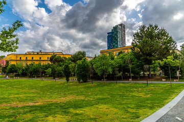 A view across the park next to the Skanderbeg Square in central Tirana, Albania in summertime