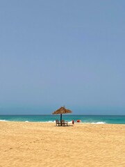 beach with umbrella and chairs