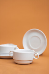 Set of stylish ceramic tableware on colour background