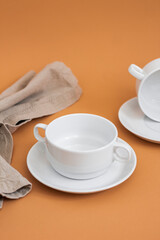 Set of stylish ceramic tableware on colour background