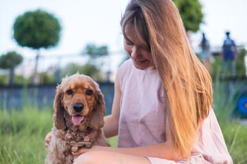 Young woman kissing her dog