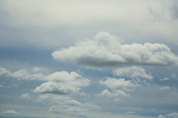High cloudiness. Overcast weather. Clouds over a green field. Beautiful background