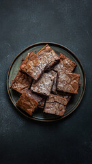 Delicious Homemade Chocolate Brownies On A Dark Plate