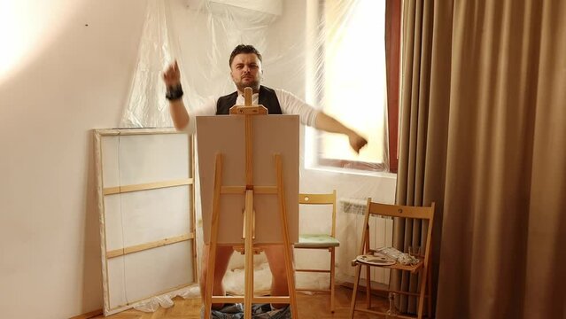Drunk man artist paints a picture with his penis