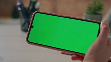 Unrecognizable woman using mockup smartphone sitting corporate office close up.