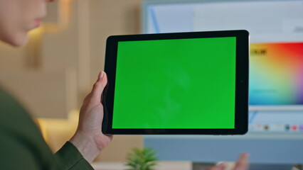 Startuper using greenscreen tablet in office close up. Unrecognizable designer