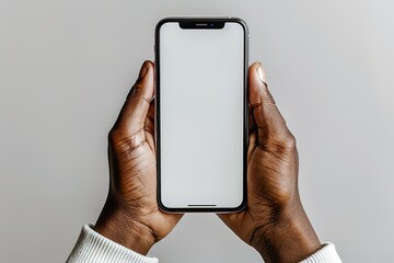 A person is holding a white iPhone in their hand