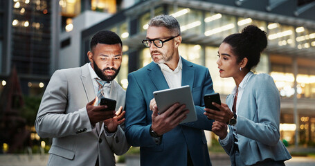 Fototapeta premium Business, people and outdoor with technology in city at night with email and communication in New York. Downtown, employees and smile as accountants with teamwork, collaboration and social networking