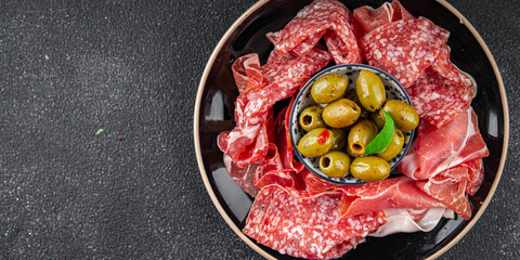 meat plate different types of meat salami, prosciutto, sausage, coppa natural food fresh appetizer meal food snack on the table copy space food background rustic top view