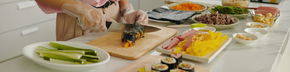 Header with woman cutting kimbap in the kitchen