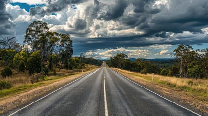Naklejka premium Endless Matilda Highway beneath the dramatic cloudy sky in Queensland