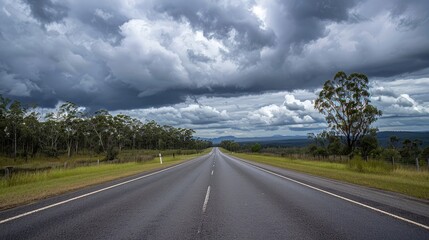 Matilda Highway stretches endlessly straight under the cloudy Queensland sky
